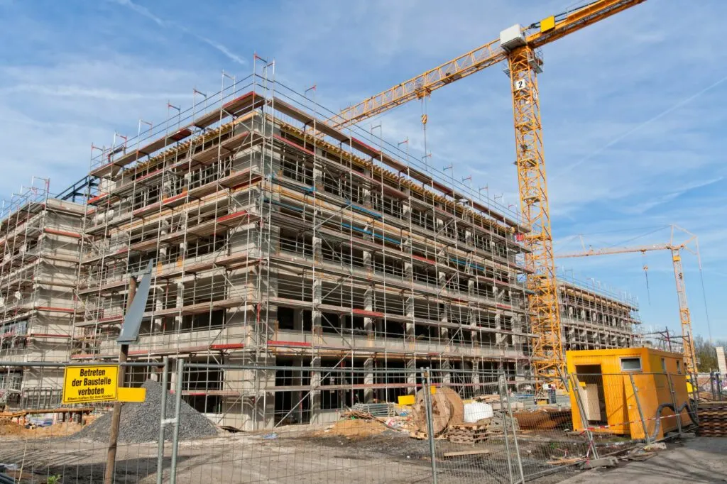 Baustelle mit Gerüst und Kran — Beispiel für ein Bauvorhaben mit SiKo-Pflicht